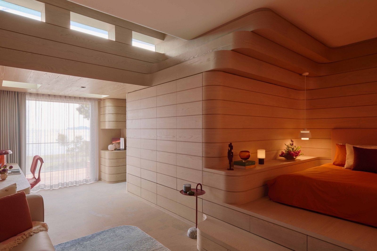 The daughter’s bedroom features custom carpentry that echoes rocky topography, with drawers that pull out to create seating