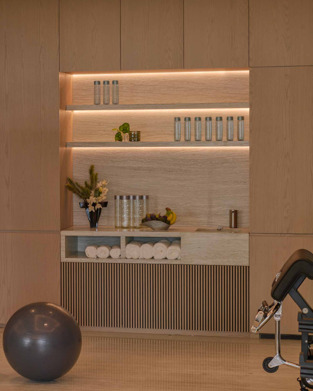 The gym features niche carpentry that neatly houses spa-like amenities