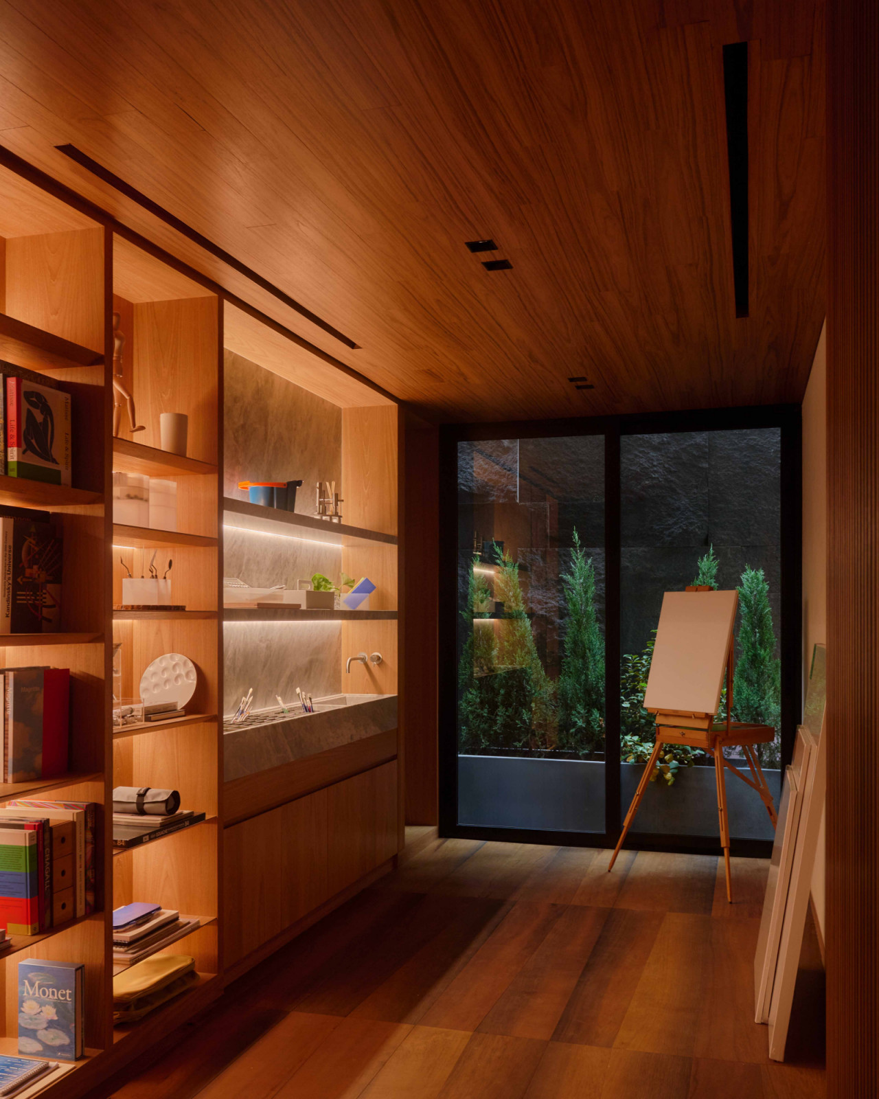 A corner with skylight garden of the basement is set up as a painting nook, complete with an easel and space to create