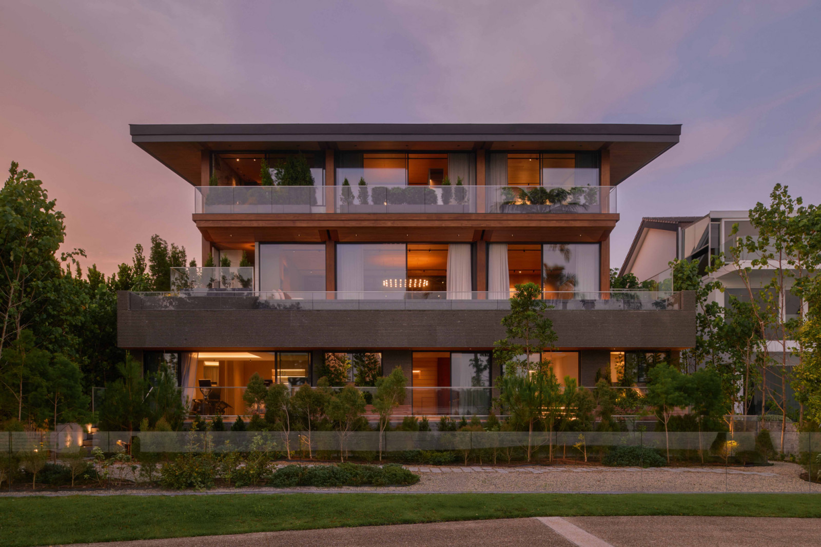 The oceanfront elevation of Plinth House, a Sentosa Cove bungalow by Type0 Architecture and Singapore’s first landed residence to employ Mass Engineered Timber (MET), is conceived as a timber pavilion set atop a stone plinth
