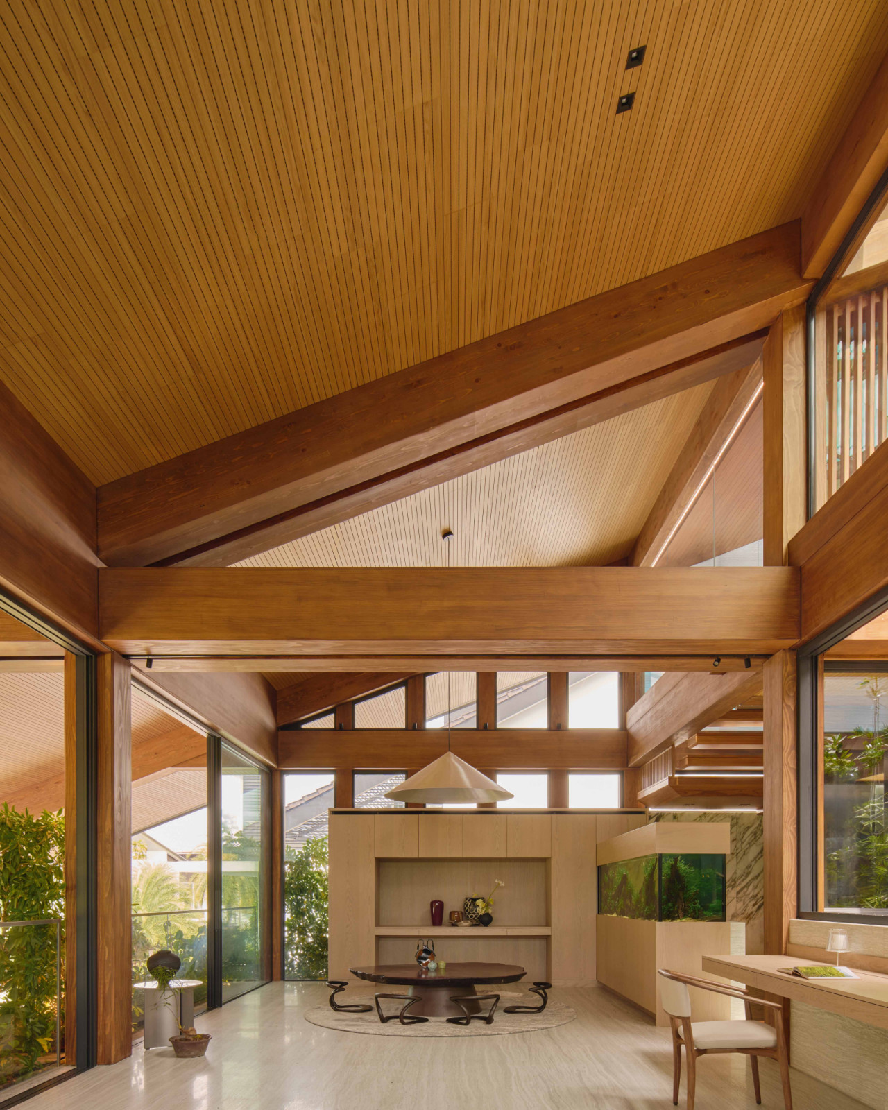 The exposed MET structure reveals the warmth of pine and spruce glulam, with the dining space and aquarium beyond