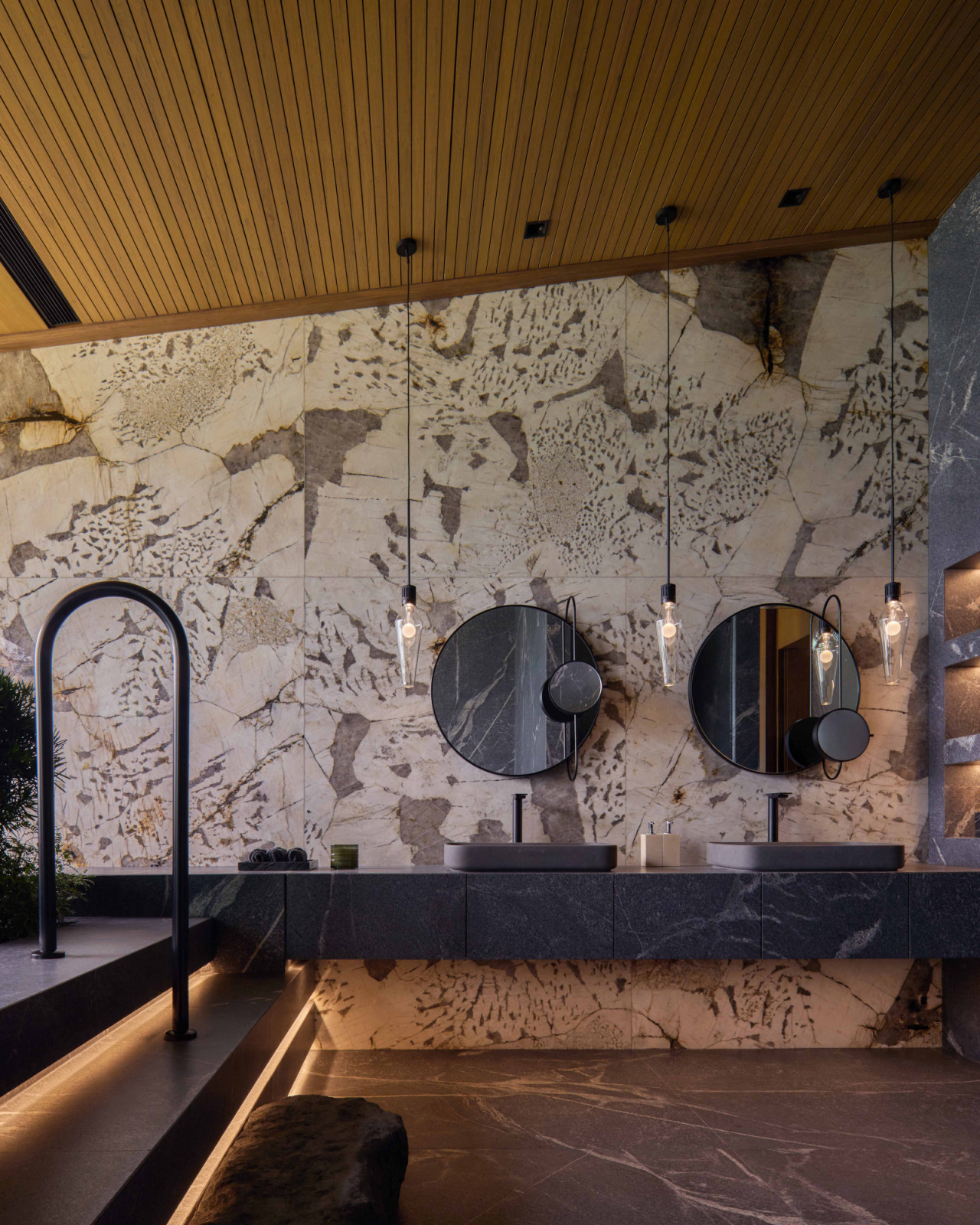 This master bathroom wall is clad in graphic Patagonia marble