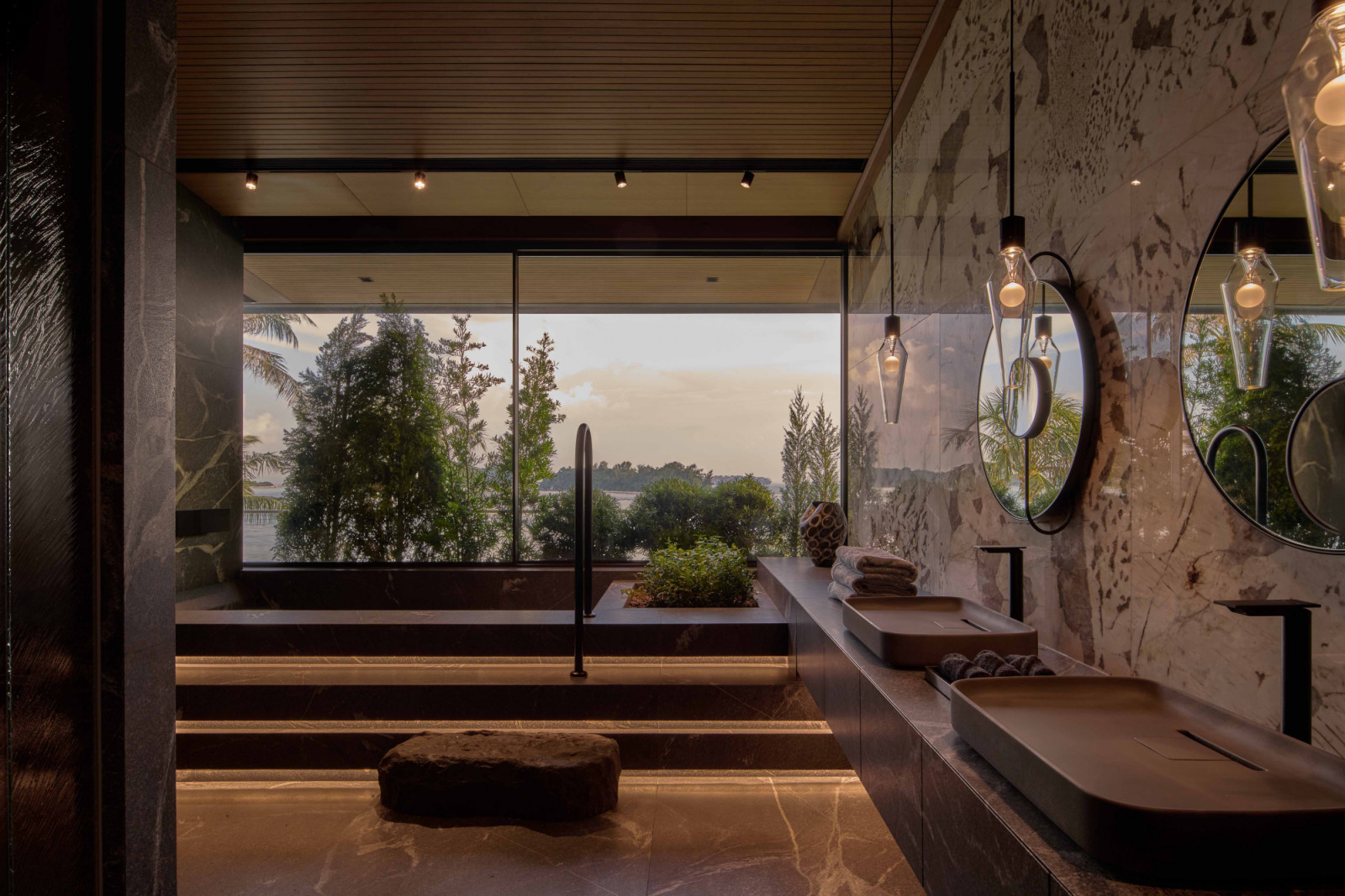 The attic-level master bathroom overlooks the ocean and surrounding greenery