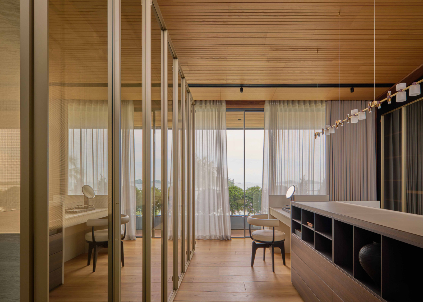 Mirrored surfaces expand the sense of space and light in the walk-in wardrobe