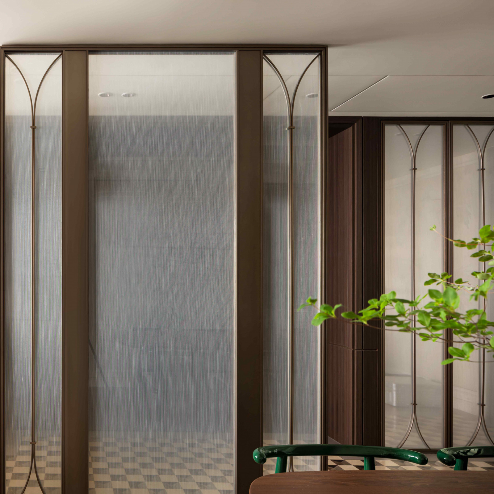 A glass partition separates the entrance from the rest of the home