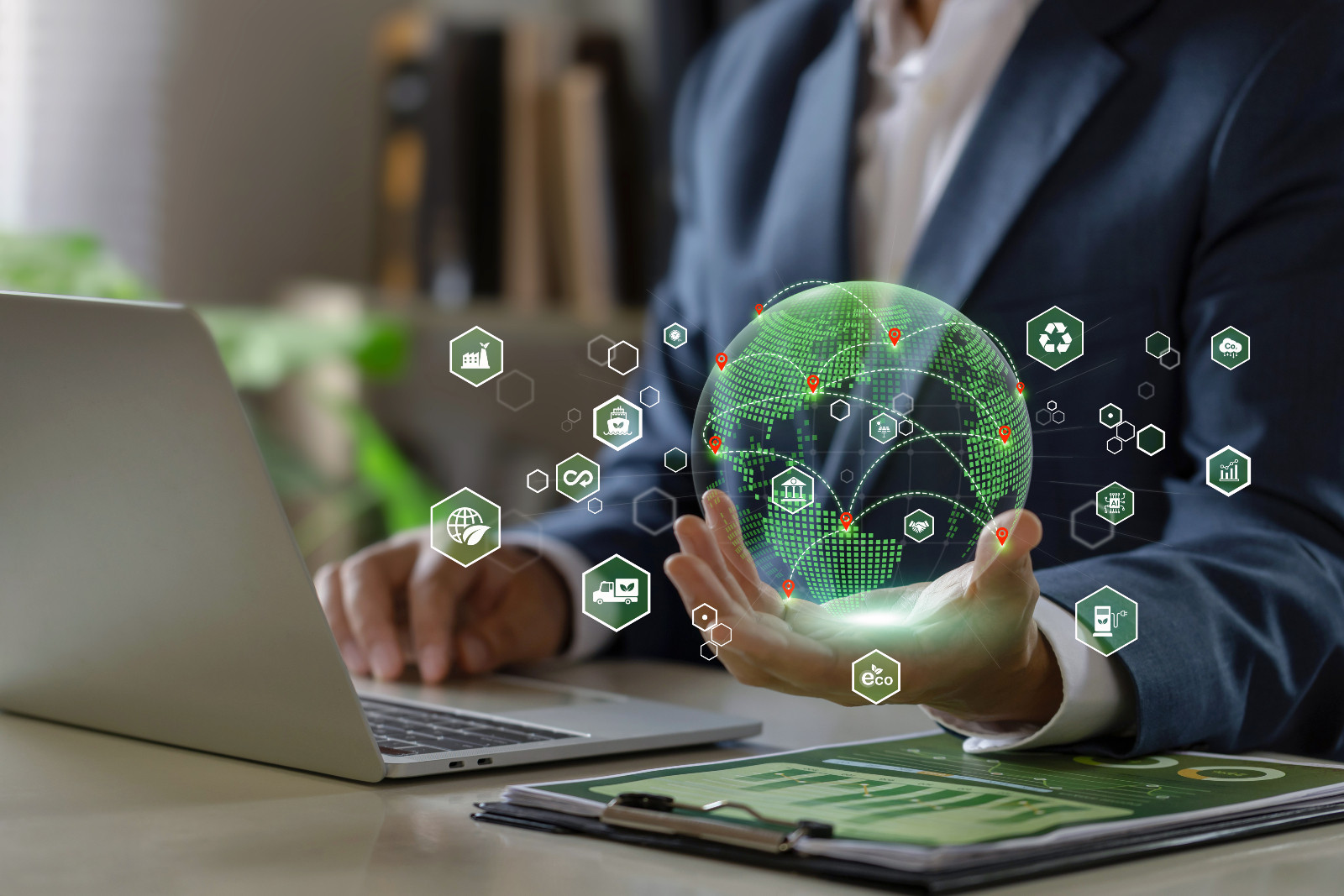 Green Logistics concept. businessman holding a green world with Clean energy transportation icons.Sustainable logistics. Environmentally friendly transportation of goods.Economic trade, import, export (photo: pcess609 / Getty Images)