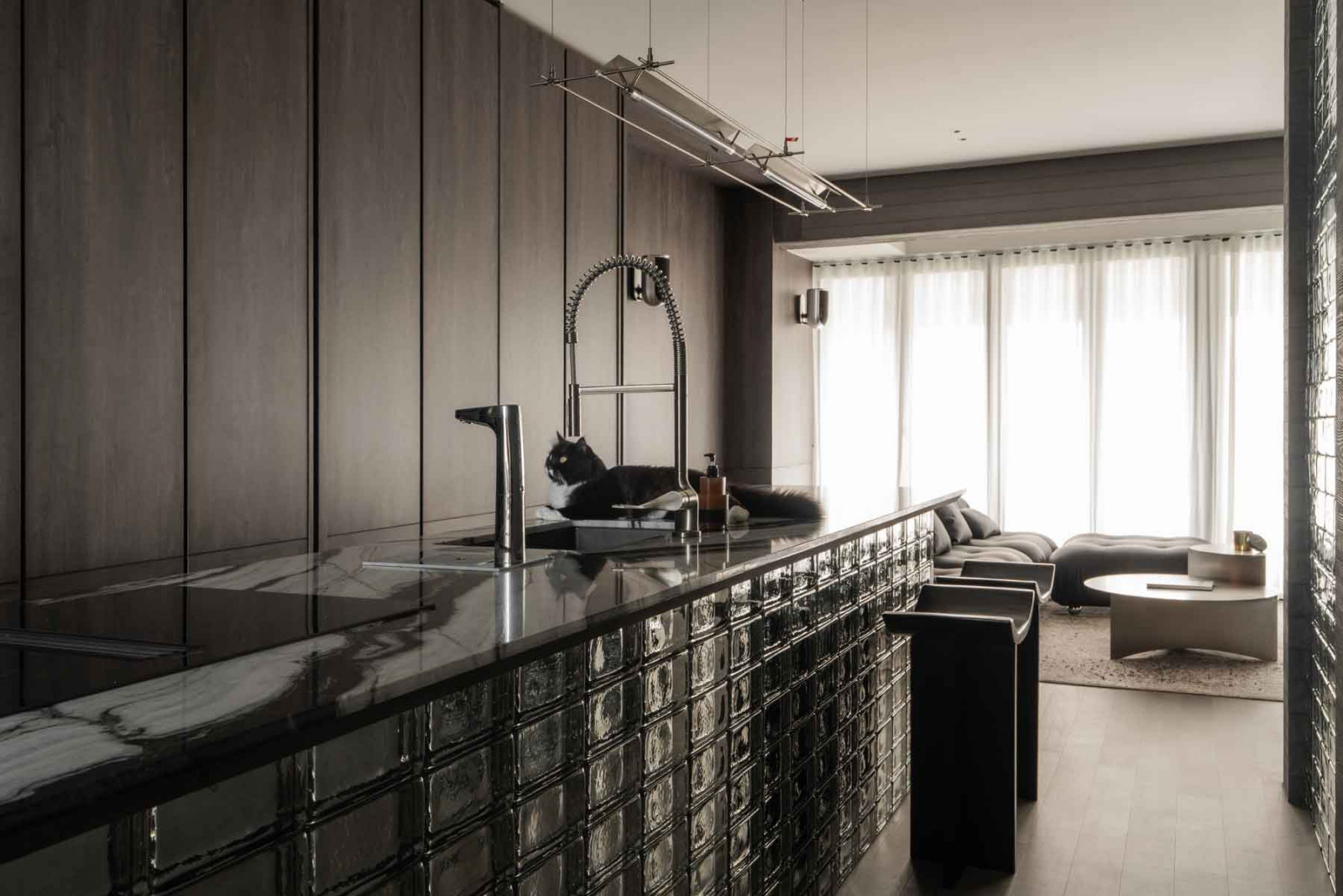 The handsomely styled kitchen is the resident tuxedo cat’s favourite hangout