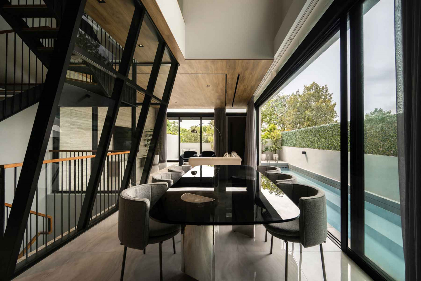 The dining area is framed by glazed surfaces that heighten the sense of openness
