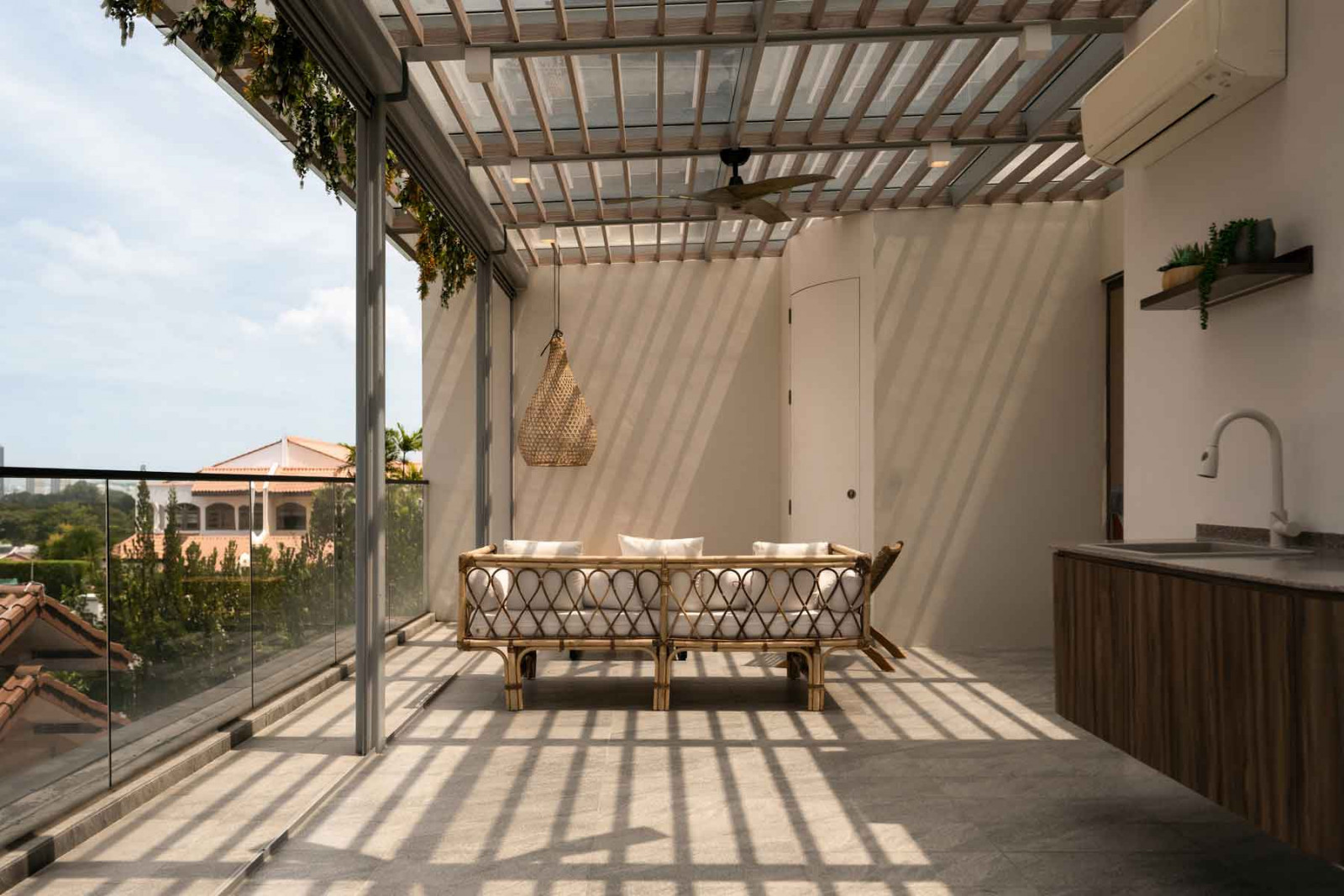 A semi-transparent rooftop canopy casts poetic shadows over the seating area