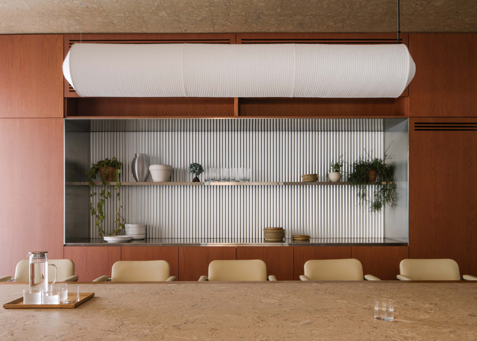 The boardroom features vintage chairs and a Tekio lamp from Santa & Cole