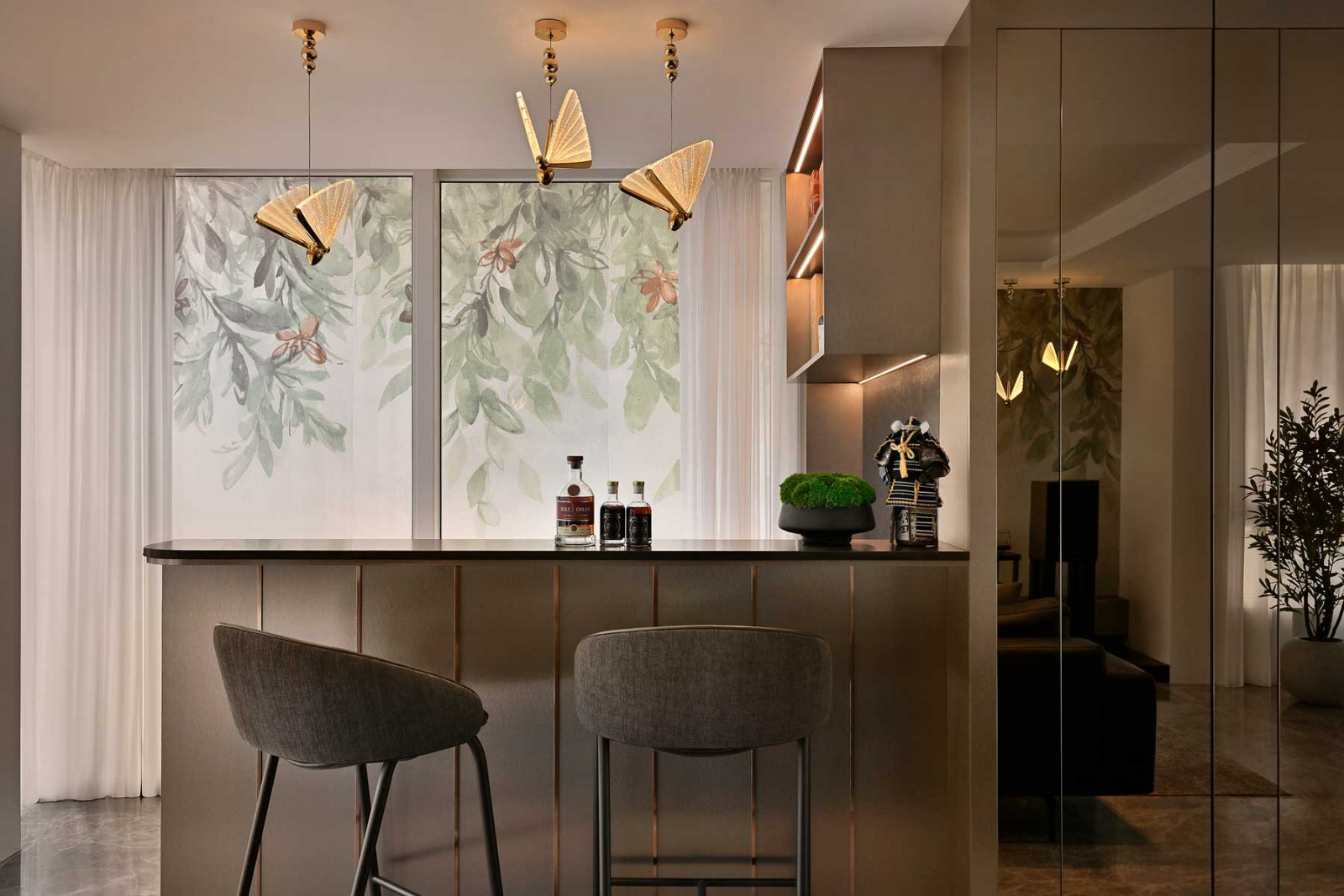 The bar area features statement tiles, complemented with butterfly-shaped pendant lights