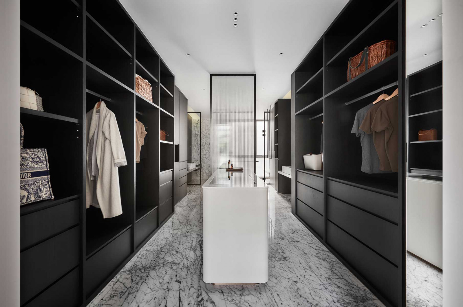 The stately, black-accented walk-in wardrobe within the master bathroom