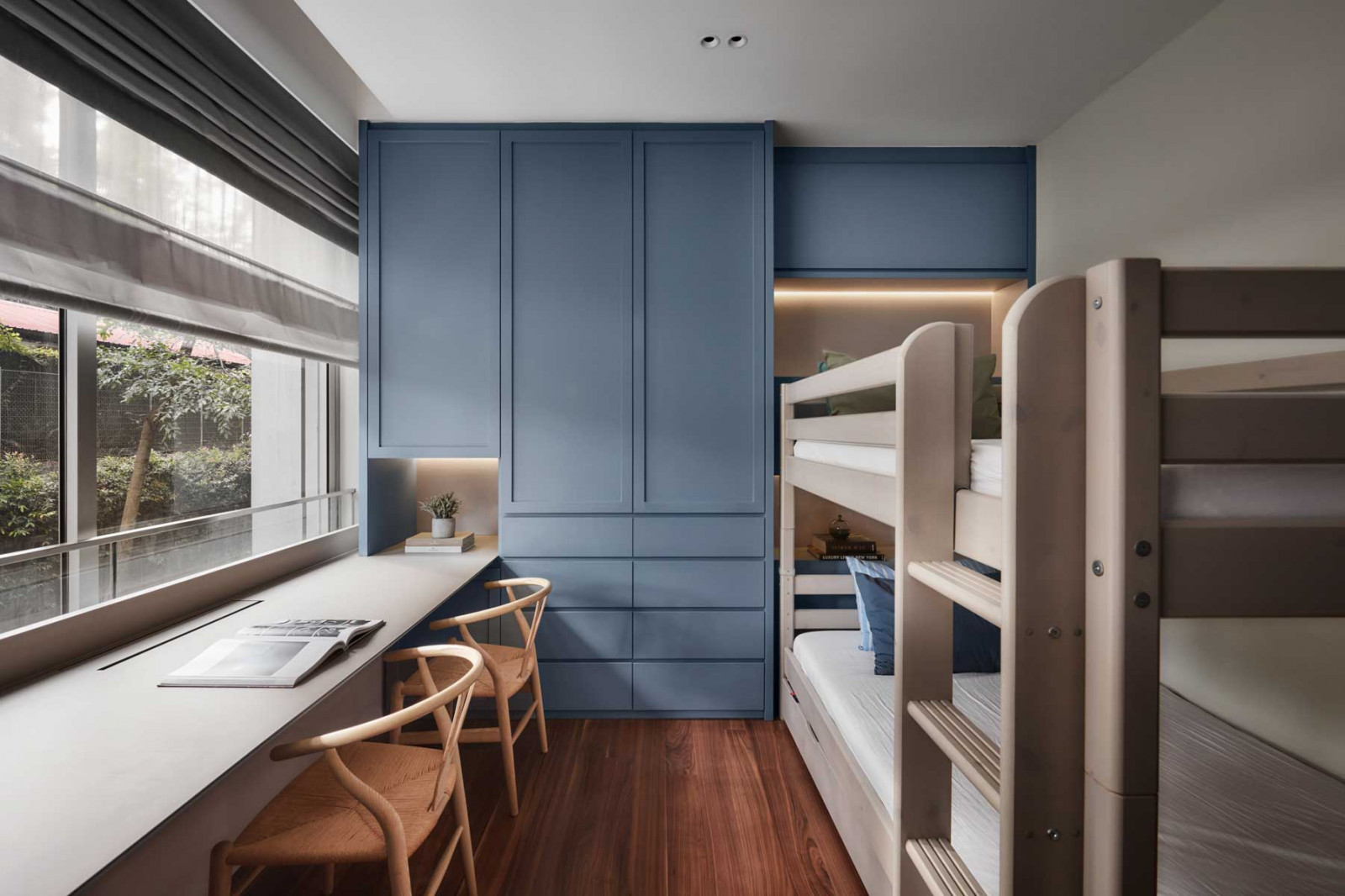 The blue-grey finish lends an accent colour to this shared bedroom