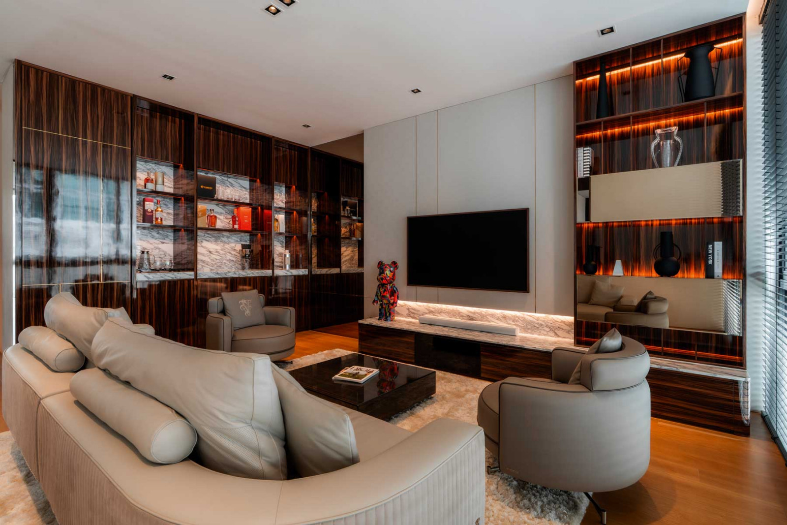 This family TV area is a snug hideaway with plush seating and a curated liquor display