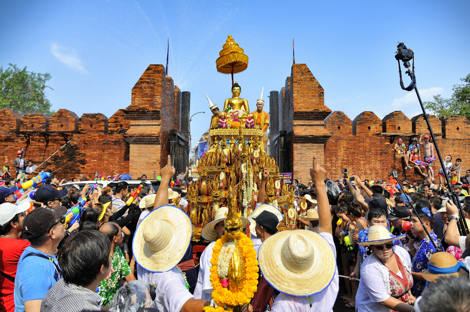 Chiang Mai, Thailand - April 13, 2015 : Chiang Mai Songkran festival, Unidentified men and women walking tradition of bathing the Buddha Phra Singh marched on an annual basis on Phra-Singh temple. with respect to faith during the annual festival.