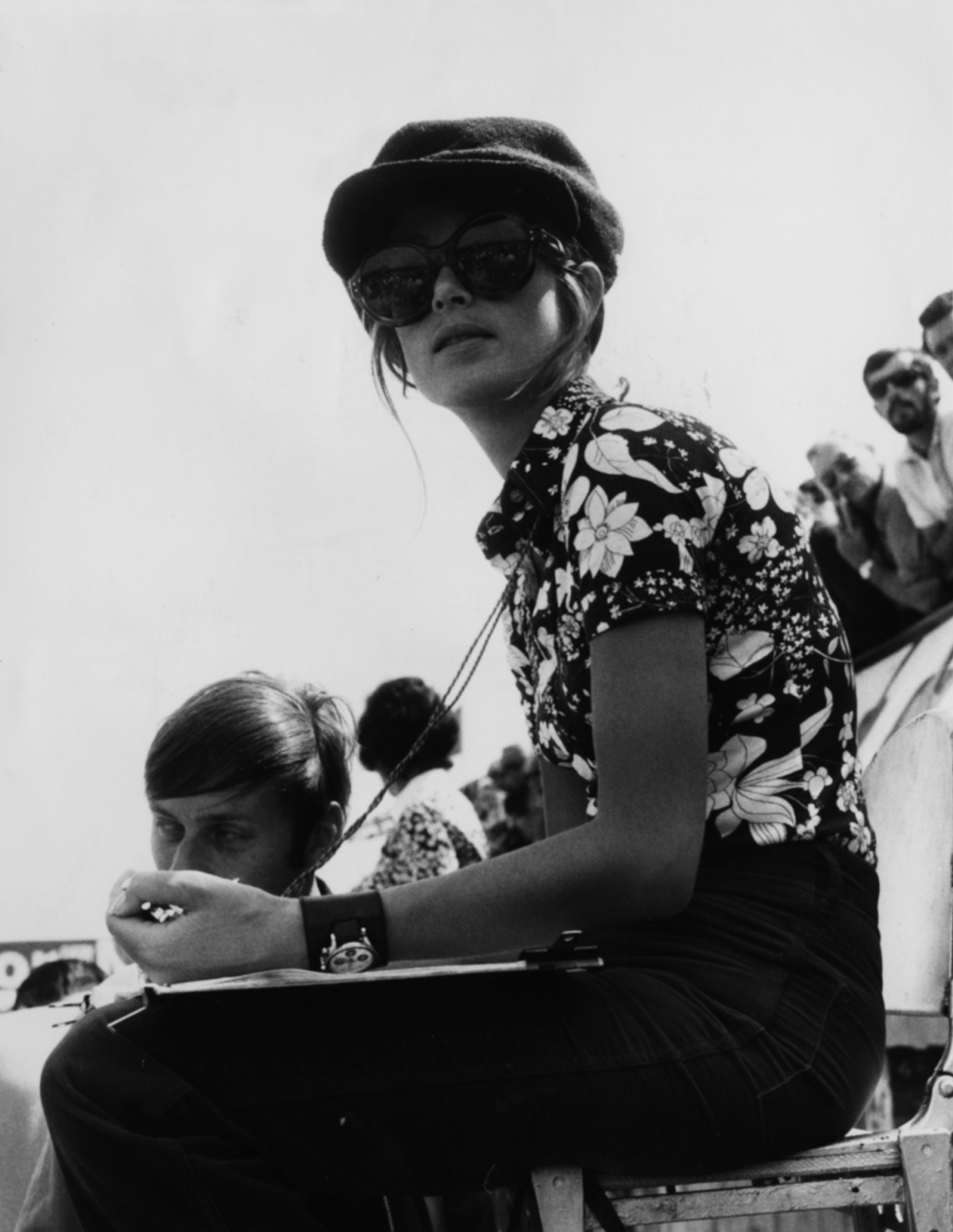 Nina Rindt, wife of racing driver Jochen Rindt, wearing a hat and large sunglasses as she watches her husband on the track during practice for the British Grand Prix, Silverstone, July 19th 1969. (Photo by Leonard Burt/Central Press/Getty Images)