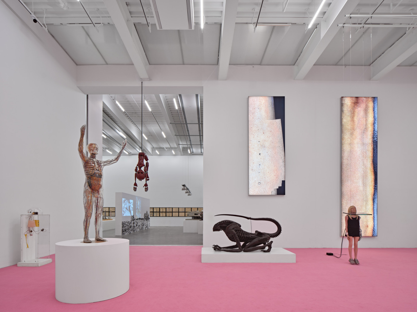 A gallery in the expanded New Museum, with the inaugural exhibition New Humans: Memories of the Future installed across a pink resin floor (Photo: New Museum)