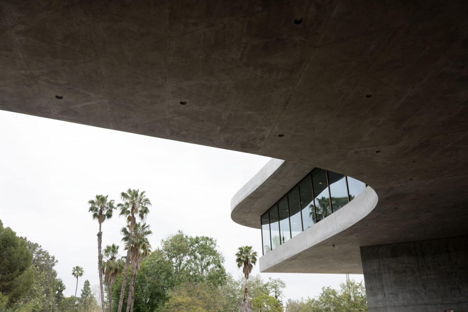The underside of the David Geffen Galleries’ cantilevered concrete slab, the building opens on 19 April 2026, concluding a two-decade transformation of the LACMA campus (Photo: Getty)