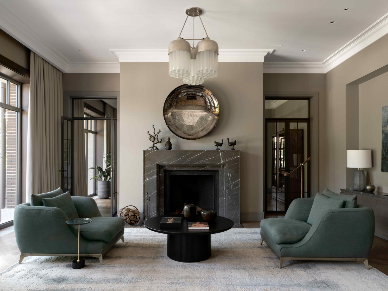 In the living room, a mirror by Christophe Gaignon hangs above the fireplace