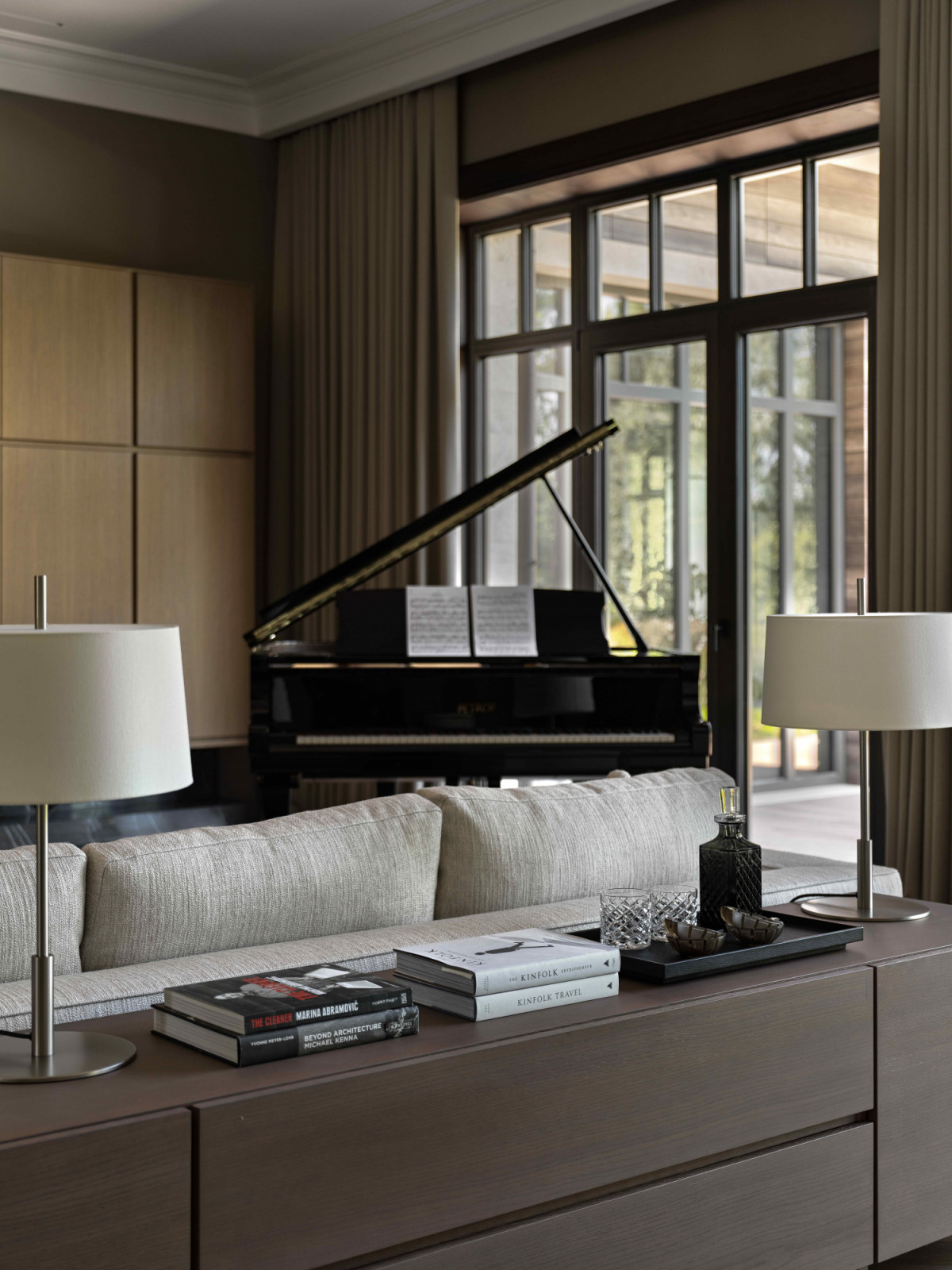 Subtle partition between the main living area, a TV and reading corner, and a dedicated space for a grand piano