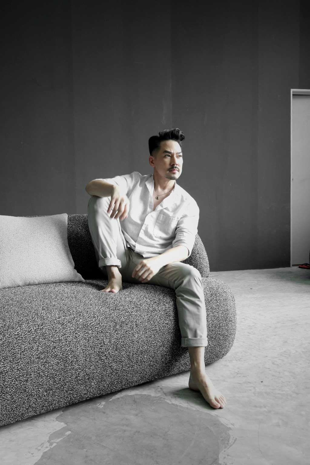 Tyler Wisler seated on his Oahu modular sofa