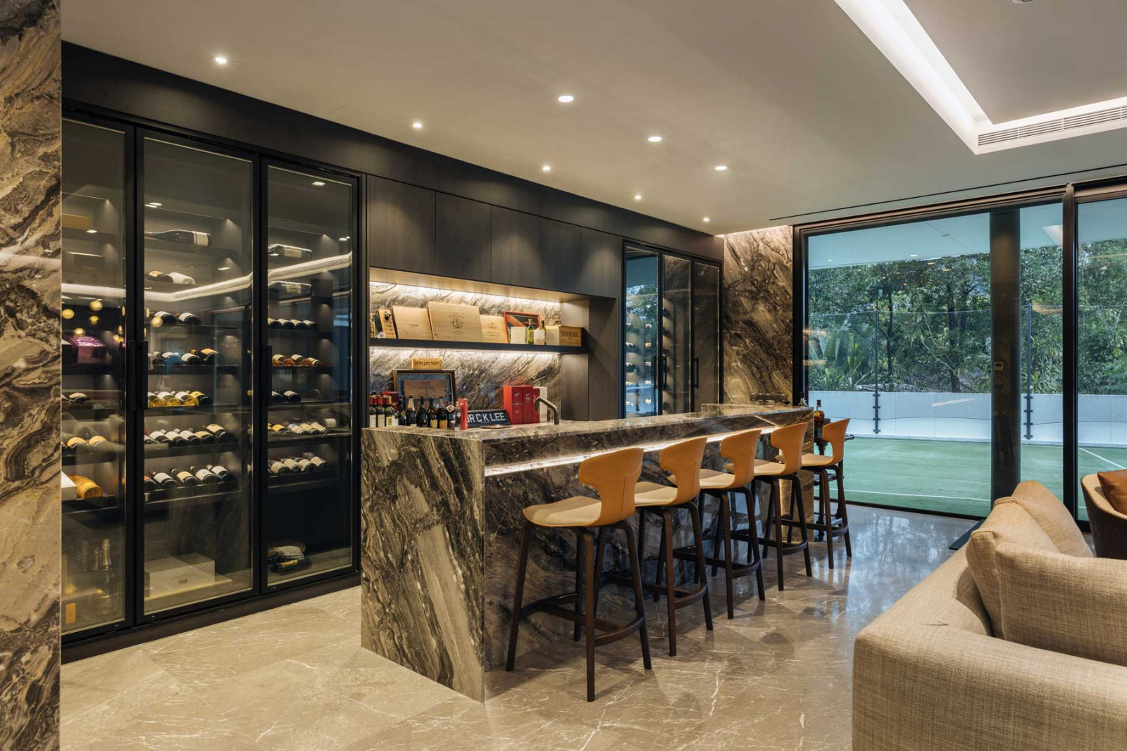 Arabescato Orobico marble is used to visually demarcate the public and semi-public areas, such as the bar with a generous wine fridge and the living room