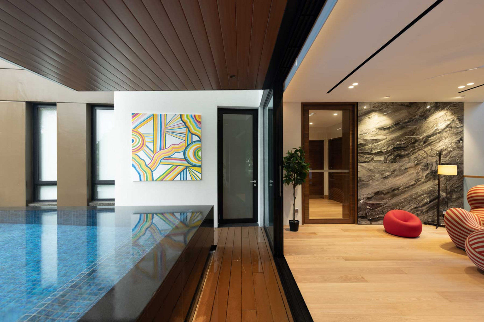 Located on the first floor, the pool welcomes guests as they enter 
the home