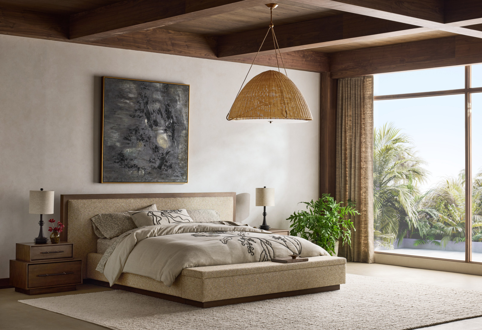 The Larchmont brings a bold architectural rhythm to the bedroom, grounding the space with fumed oak and smoky finishes. The Larchmont Upholstered King Bed anchors the room with its streamlined profile and integrated storage bench, featuring a textured weave that softens the headboard. Complementing this foundation, the Larchmont Stacked Oak Nightstand features a stacked design thatplaces a smaller drawer atop a larger one, accented with a plinth base and chamfered edges (Photo: courtesy of Crate and Barrel)