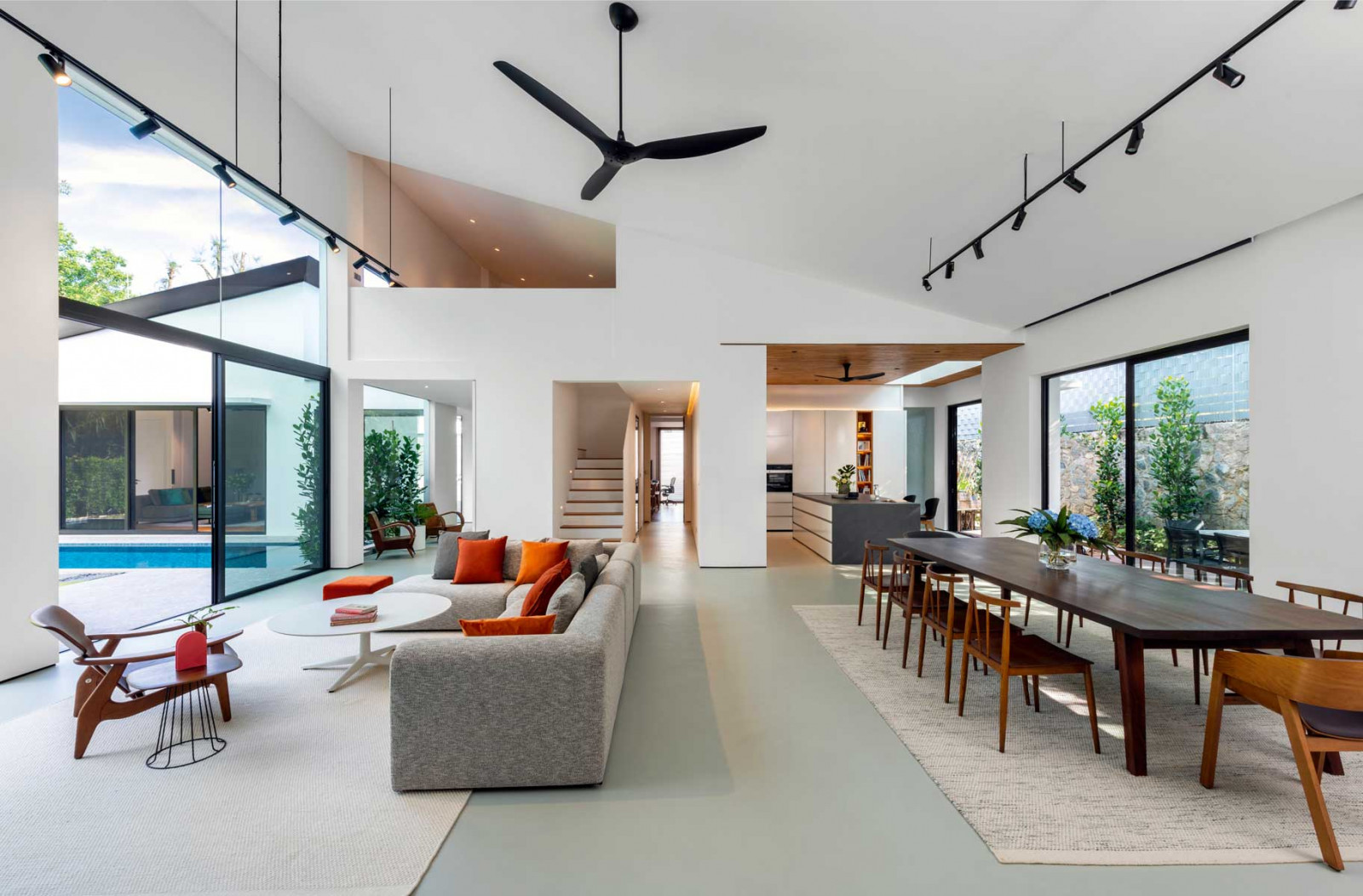 A column-free living and dining space defines the Swiss Club Lane residence, creating a light-filled interior with seamless indoor-outdoor access