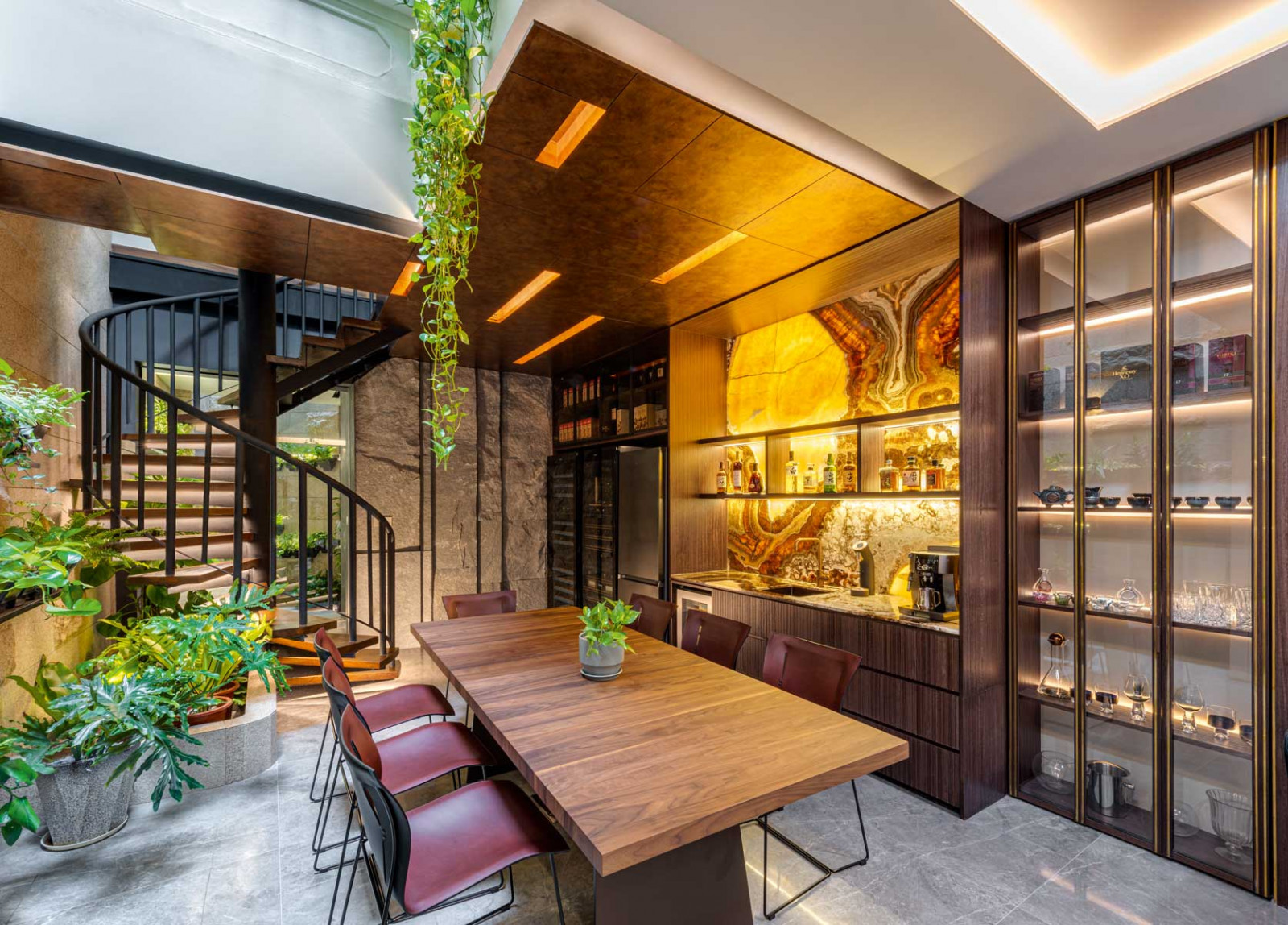 In the Ann Siang Hill shophouse, a lush courtyard dining area and spiral staircase introduce a “secret garden” within the workplace