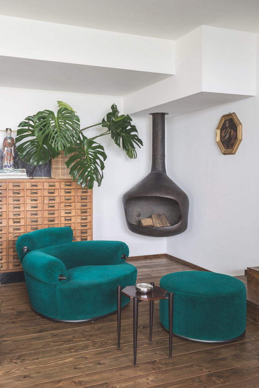 Luigi Caccia Dominioni’s P20B Toro armchair and footstool for Azucena anchor this sitting area, alongside a 1960s fireplace by Mario Vender