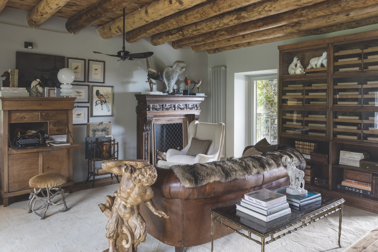 Marco Zanuso’s Senior armchair for Arflex accompanies a late 19th-century neoclassical walnut fireplace, a 1950s Maison Bagues coffee table, a walnut desk from the 1800s and a 1700s carved wooden faun sculpture