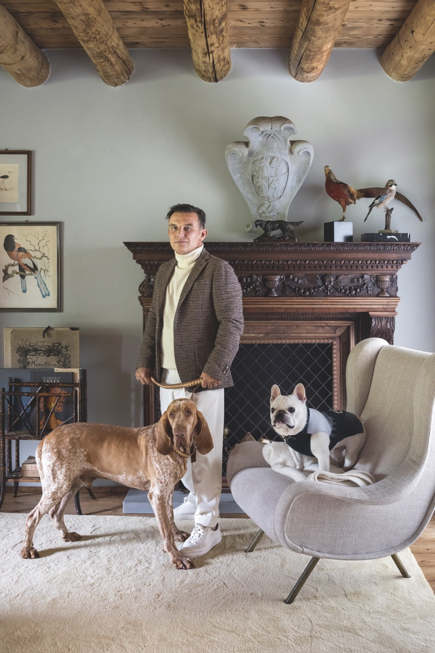 Maurizio Azzimonti, Moncler’s worldwide window designer director, with two of his pet dogs