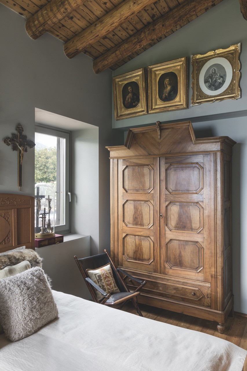 A bedroom with a pair of 18th-century paintings above a late 19th-century walnut wardrobe