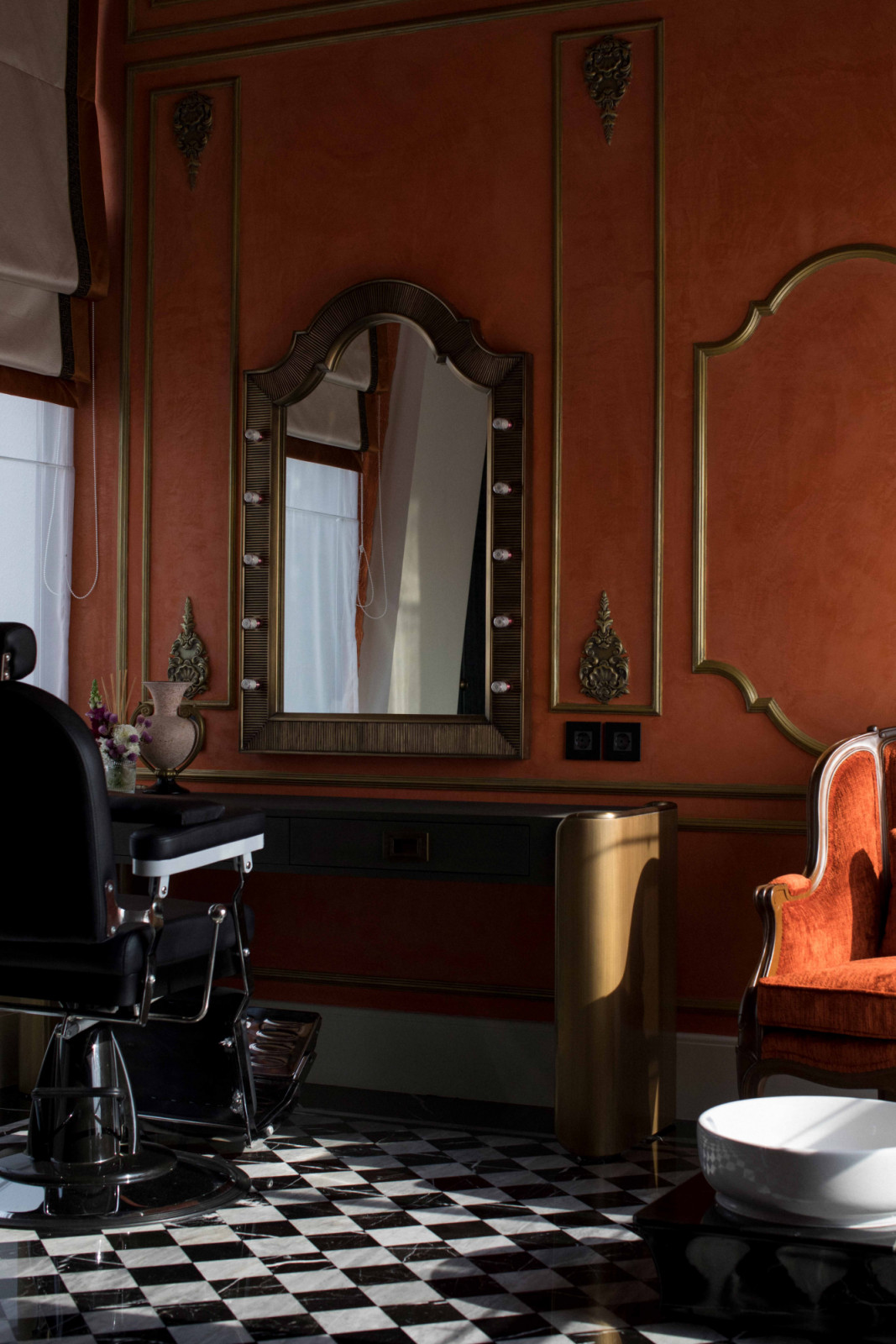 A barber chair and theatre mirror give this grooming room a cinematic flair