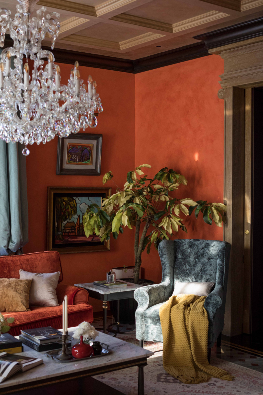 A richly layered corner beneath a sparkling crystal chandelier