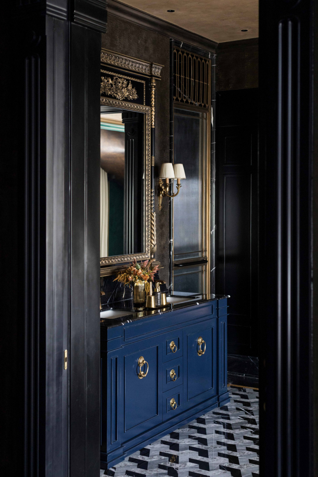 A deep-blue console and gilt mirror punctuate this richly detailed foyer