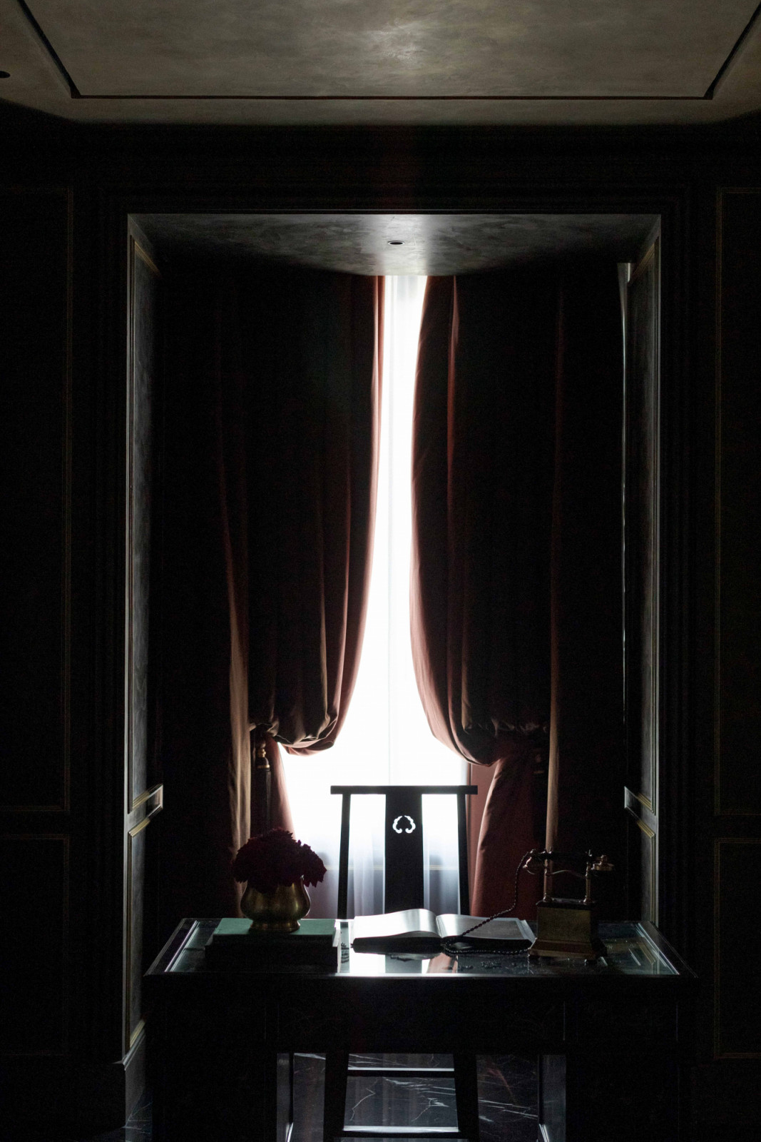 Thick curtains at the study allow for adjustable privacy while casting a dramatic silhouette.