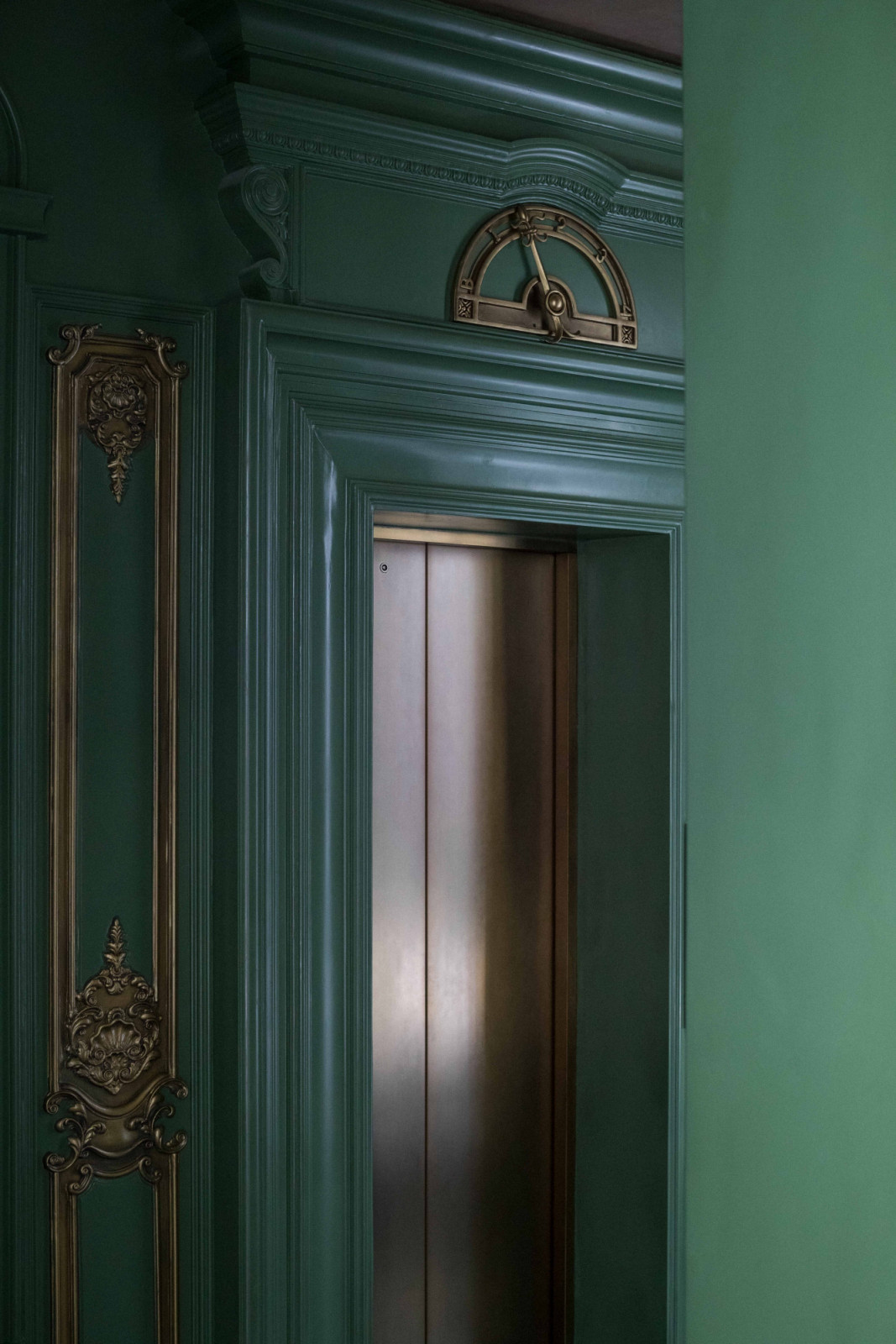 The lift lobby at The Continental is dressed in green, with an old-school needle indicator marking the floors