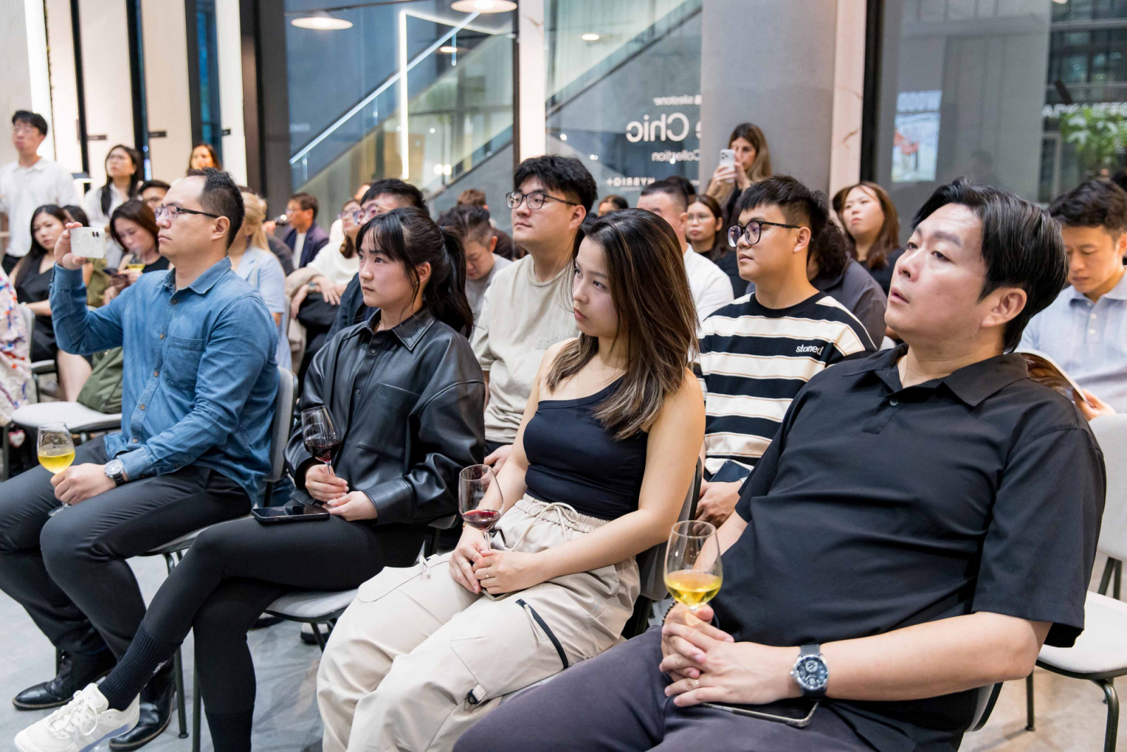 Guests listening closely to the panel discussion