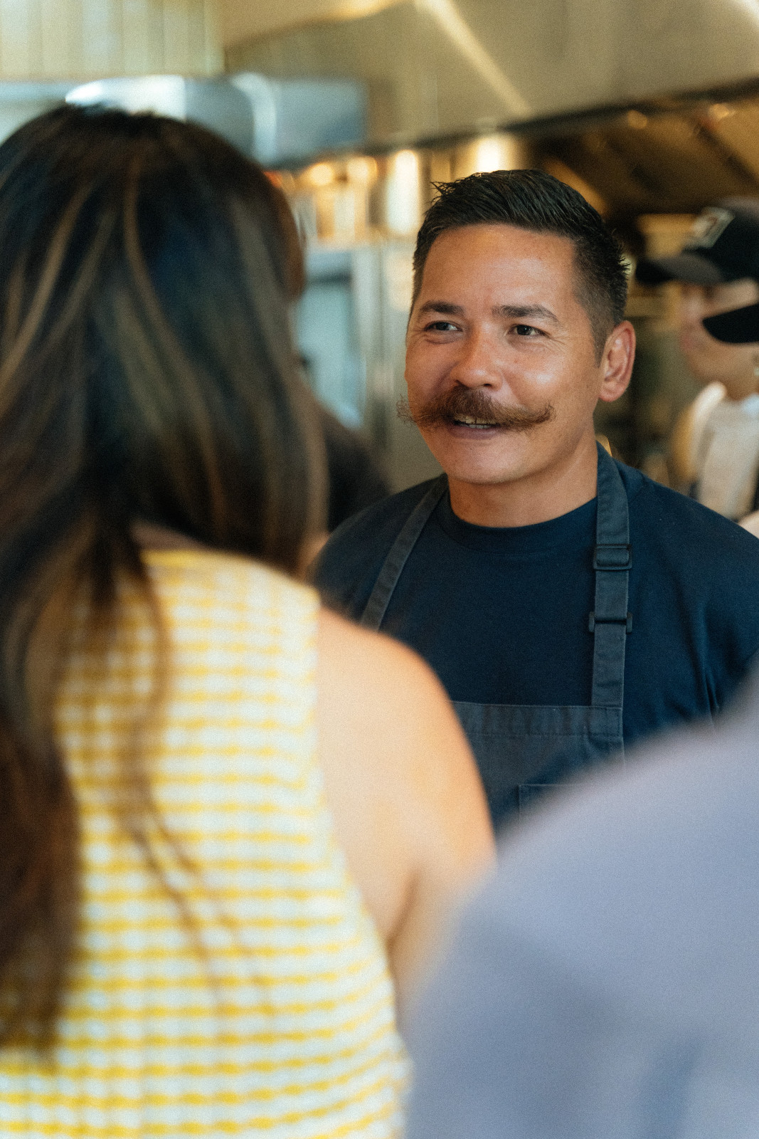 Chef Josh Boutwood chatting with guests about their sutukil menu