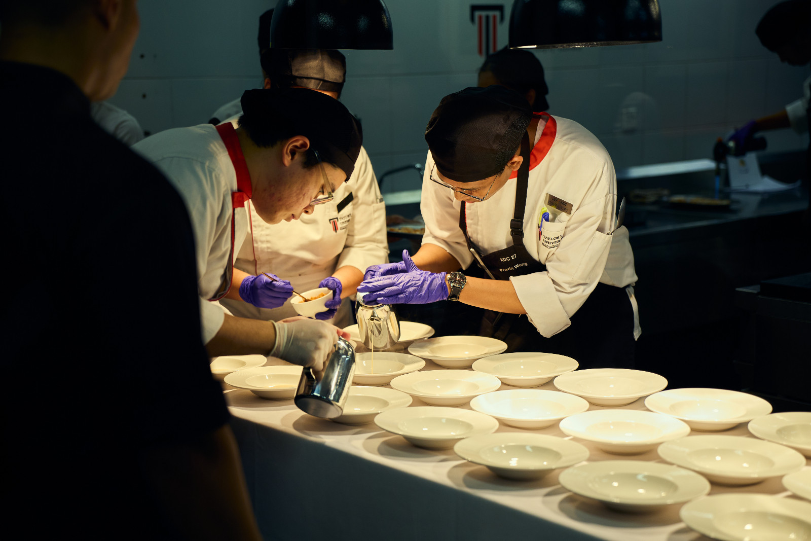 COL participants in the midst of dinner preparation after a full day of masterclasses with Chef Hans and Chef Yuda