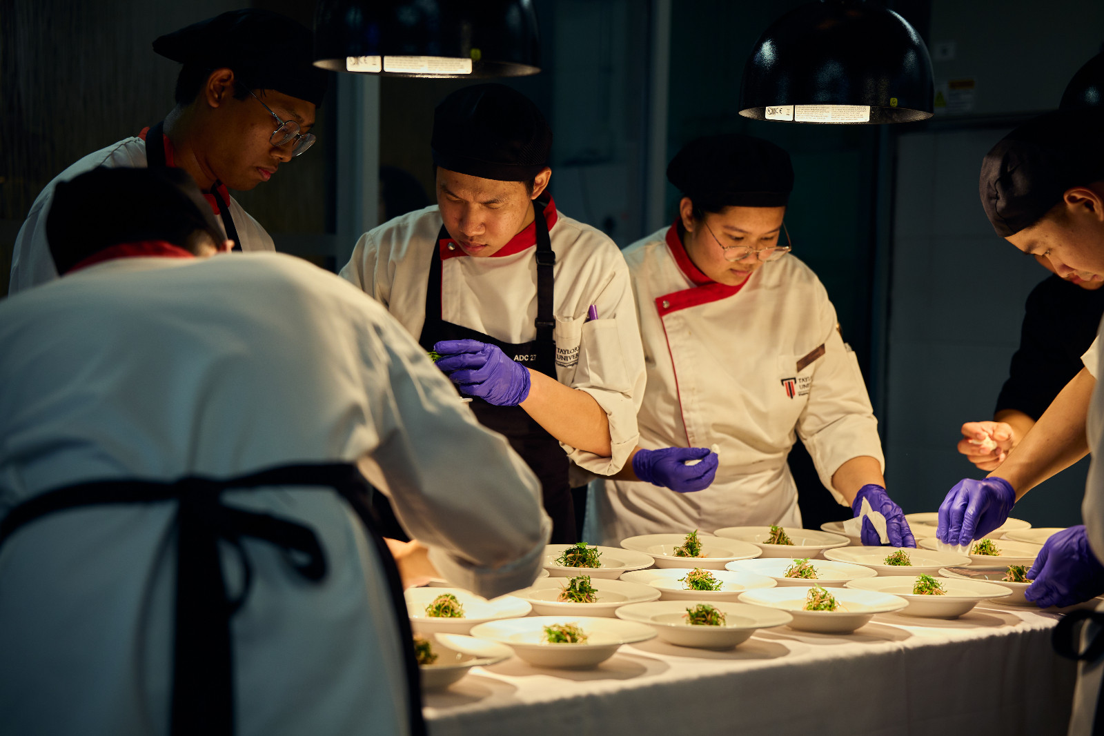 Attention to detail is important in the kitchen: Students tidy up plating together, working as a team