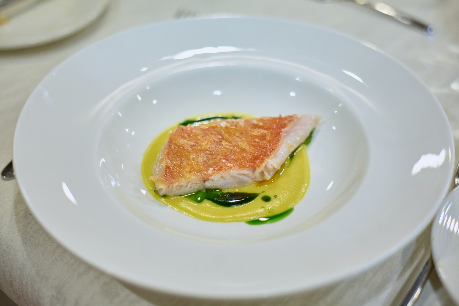Main Course, prepared under the guidance of Chef Hans: Crispy scales Kinmedai with an Aromatic Curry Emulsion and Ginger Flower Relish