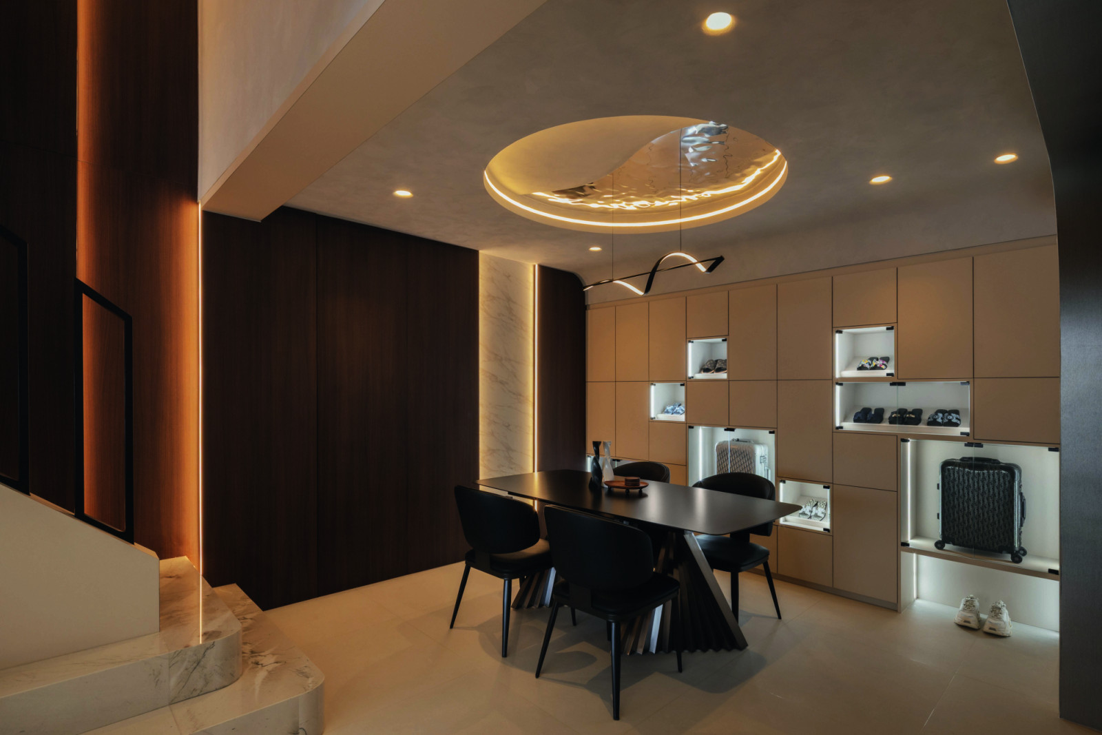 In the dining room, a built-in display wall integrates storage with recessed niches that showcase curated objects and travel keepsakes