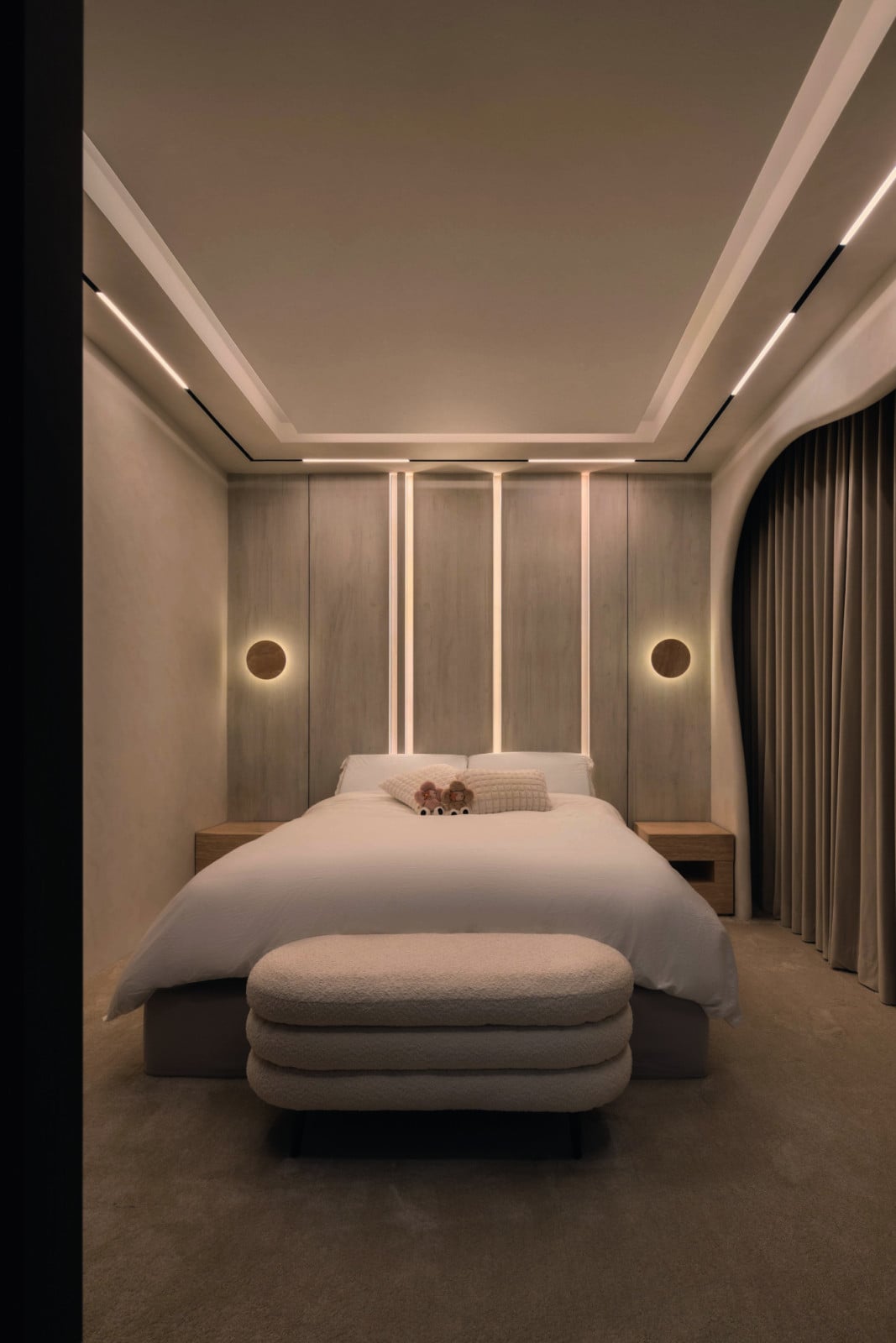 The curvy design language continues in this bedroom, where a muted palette fosters a stylish yet cosy retreat