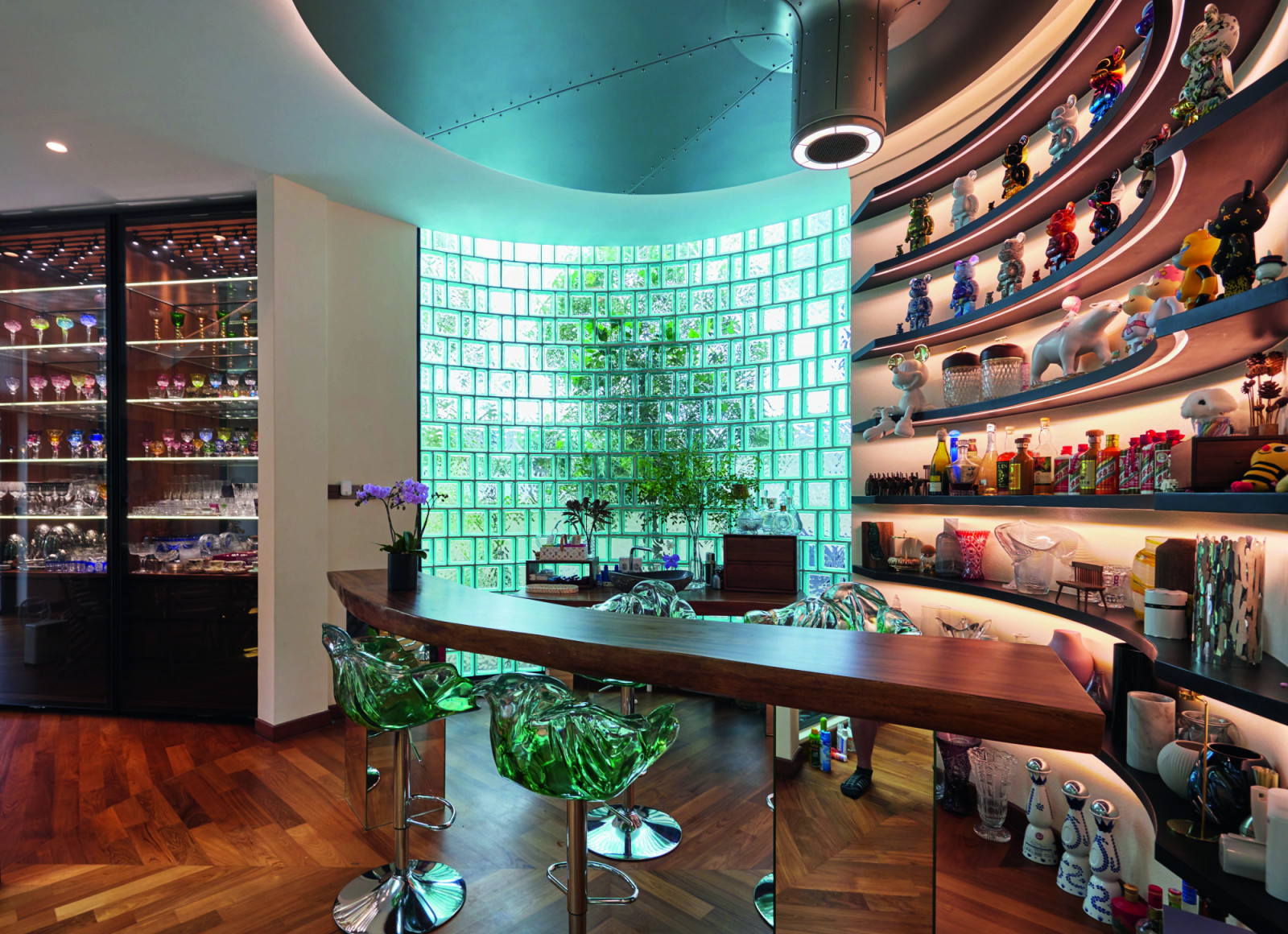 The bar of the bungalow at Opera Estate features a pair of Edra’s Ella chairs whose look mirrors that of the glass-block wall