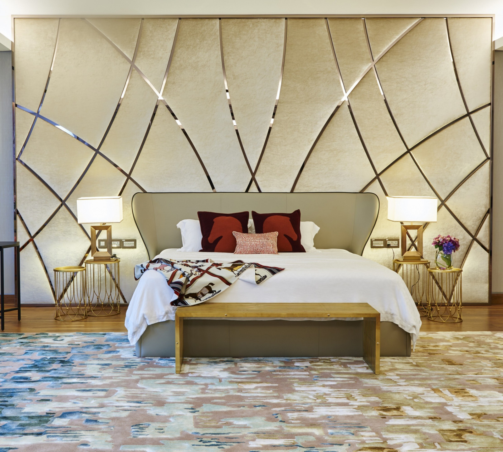 The headboard in the heart of the master suite is a grand display of elegant curves reminiscent of blades of grass blowing quietly over an open field