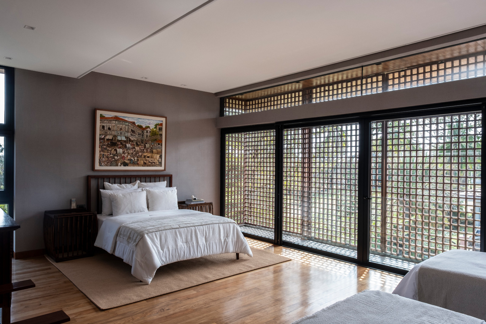 A cosy bedroom in neutral tones and locally-made furniture in a Batangas, Philippines home designed by LYS Architecture