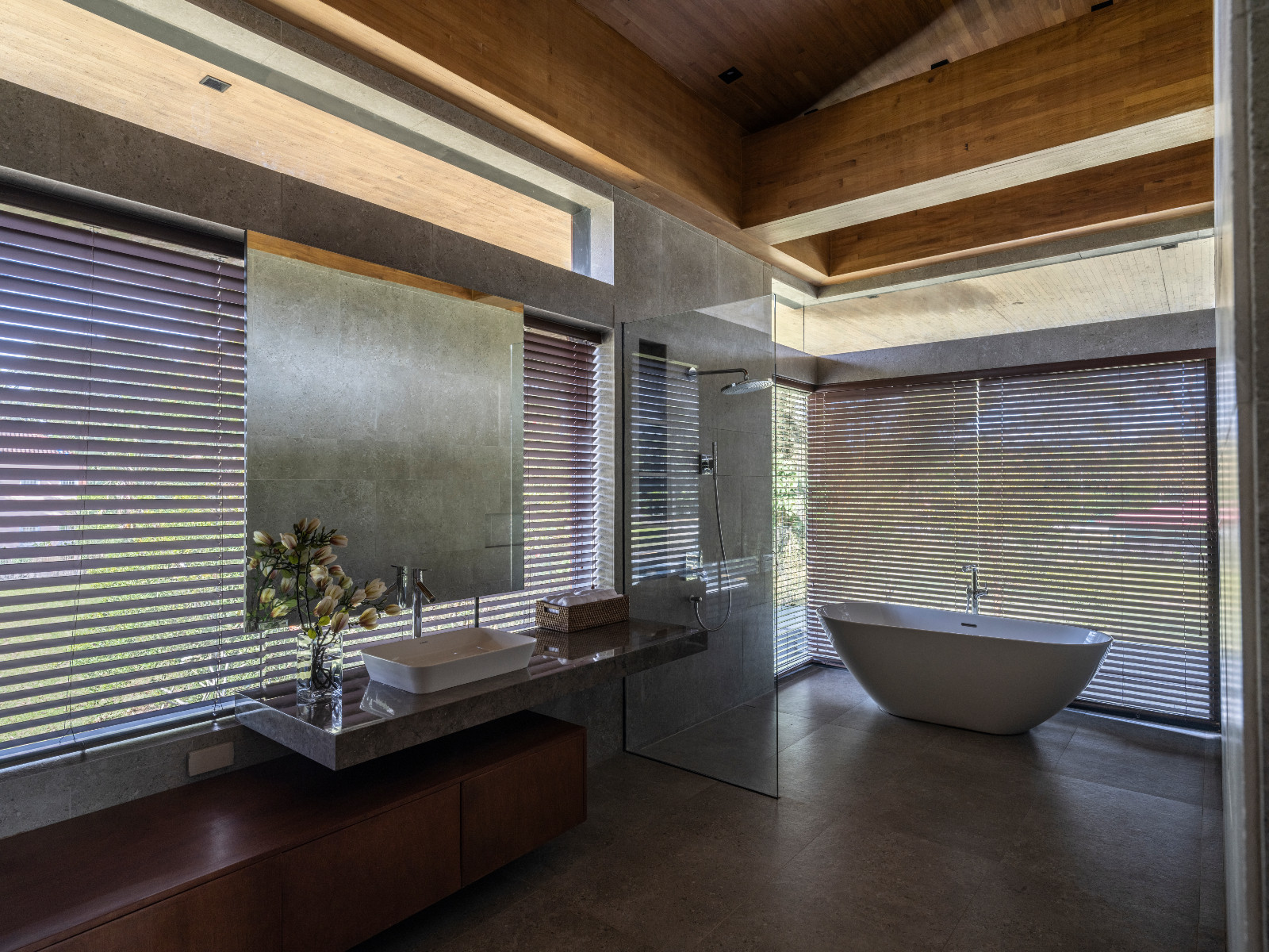 A serene bathroom with expansive views of a Batangas, Philippines home designed by LYS Architecture